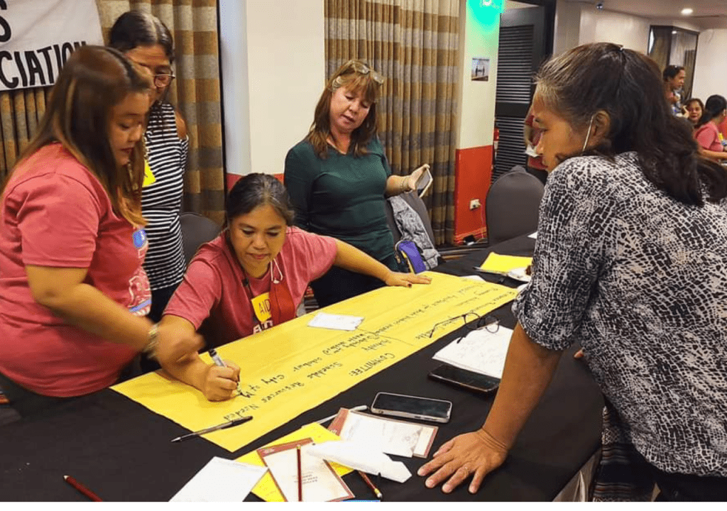 a group of people discussing around a table