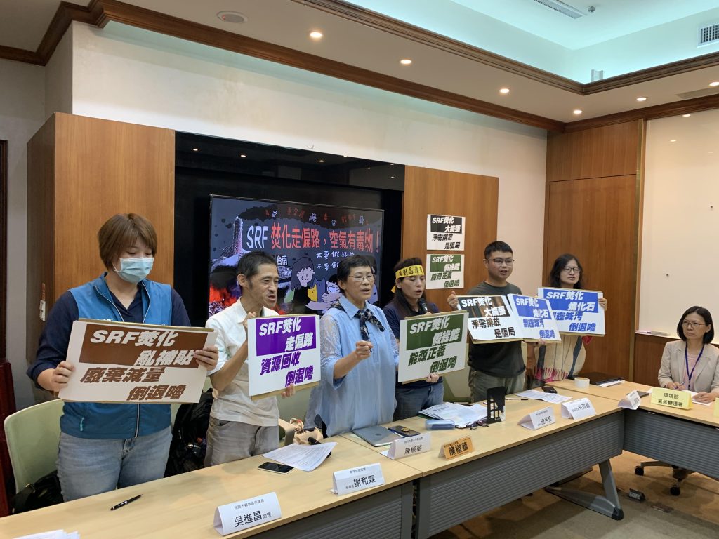 Group of people holding up signs. 