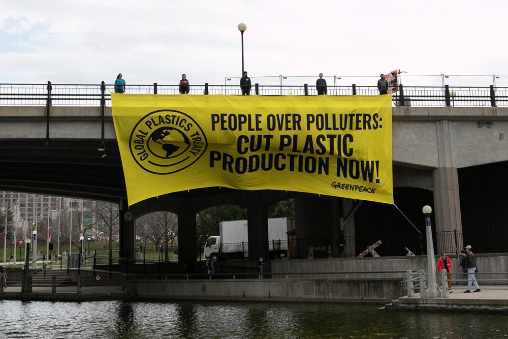 banner draped over bridge reads: 