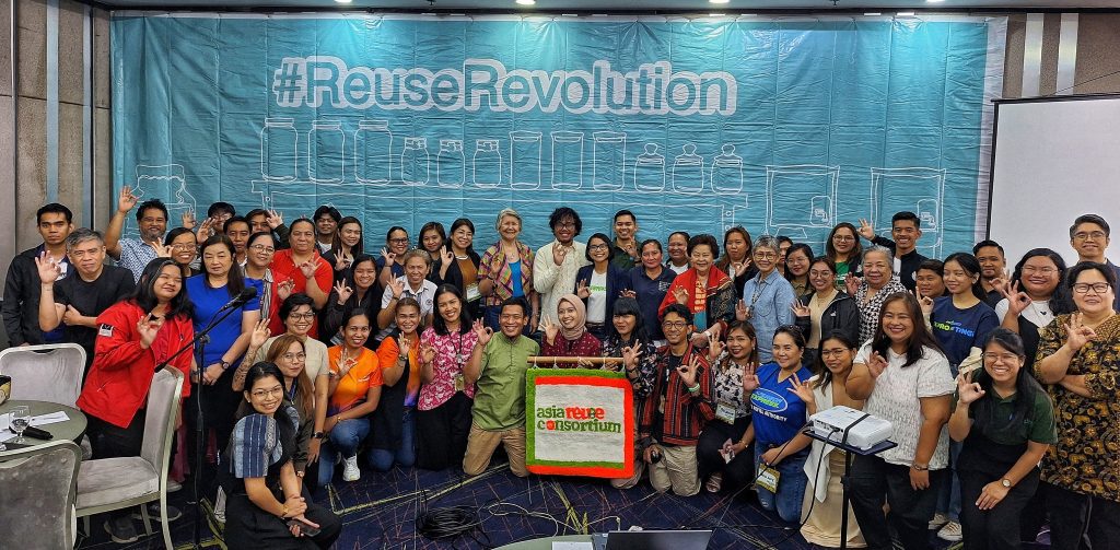 group of people holding a sign that says Asia Reuse Consortium