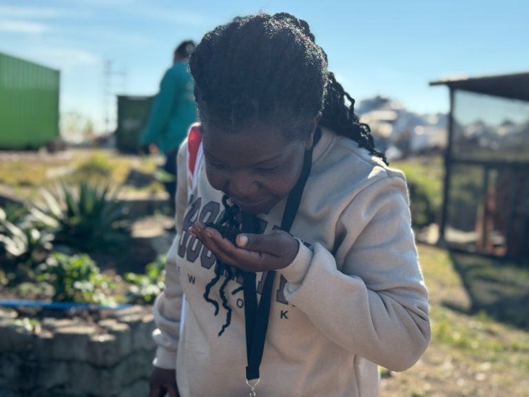 A participant of the Africa Zero Waste Academy examines an organic fertiliser during a training session.